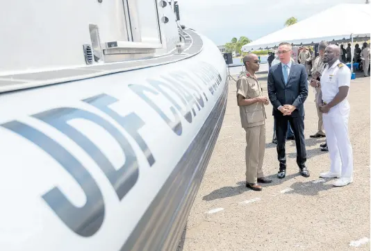  ?? FILE ?? In this 2019 photo former Chief of Defence Staff Lieutenant General Rocky Meade (left) with Eric Khant (centre) then chargé d’ affaires, United States Embassy and Lieutenant Aceion Prescott at the Boston Whaler and SAFE Boat Handover Ceremony at Jamaica Defence Force Coast Guard, Port Royal.