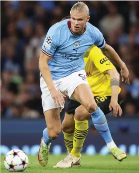  ?? /Getty Images ?? Erling Haaland of Manchester City in action with Niklas Sule of Borussia Dortmund at Etihad Stadium .
