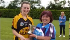  ??  ?? Larah Campbell receives the cup from Kathleen Kehoe.