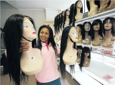 ?? Picture: Esa Alexander ?? Fanny Fume, saleslady at Queen’s Hair Beauty in Cape Town’s CBD, sells wigs costing from R650 to R3,500.