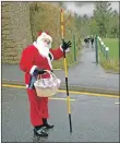  ??  ?? Santa took time out from his hectic festive schedule to help Lundavra Primary School pupils cross the road.