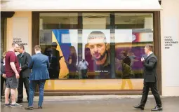  ?? MARKUS SCHREIBER/AP ?? Ukrainian President Volodymyr Zelenskyy speaks on a screen inside the “Russian War Crimes House” on Sunday near the site of the World Economy Forum.