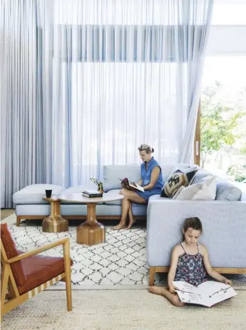  ??  ?? LIVING AREA (top left) Striking floor-to-ceiling curtains add scale and softness. An L-shaped sofa designed by interior designer Malvina Stone and made by Casa Villa in Perth is paired with an Empire Homewares cushion, ‘Blava’ easy chairs from...