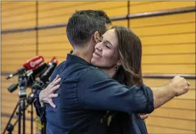  ?? MARK MITCHELL — NEW ZEALAND HERALD VIA AP ?? New Zealand Prime Minister Jacinda Ardern, right, hugs her fiancee Clark Gayford after announcing her resignatio­n at a press conference in Napier, New Zealand, on Thursday.