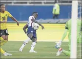  ?? FERNANDO LLANO — THE ASSOCIATED PRESS ?? United States’ Tim Weah, center, scores his side’s opening goal against Jamaica during a World Cup qualifying match on Tuesday.