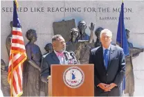  ?? BOB BROWN/RICHMOND TIMES-DISPATCH ?? Eric Branch introduces Virginia Gov. Terry McAuliffe, right, during a ceremony dealing with the restoratio­n of voting rights at the Virginia Civil Rights memorial at the State Capitol in Richmond, Va., on Monday. Branch, who served over four years in...