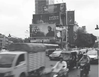  ?? DRANIL MUKHERJEE / AFP / GETTY IMAGES ?? Sacred Games, the upcoming Indian series on Netflix, is advertised on billboards in Mumbai. Subscriber growth is critical for the California-based streaming giant as its market value surges past US$46 billion.