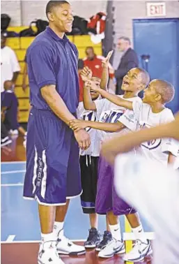  ??  ?? Kids look up to Florida’s Bradley Beal during break in clinic. He and other top prospects educated youngsters on healthy lifestyle.