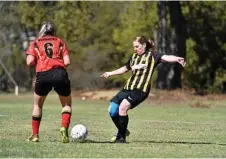  ??  ?? Gatton Red’s Tahlia Sudhaus (left) competes for the ball with Dalby’s Brenda Brown.