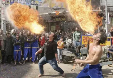  ?? NARINDER NANU/GENCE FRANCE-PRESSE ?? DANCERS perform a fire breathing act during a procession to mark the 669th anniversar­y of the birth of Hindu Guru Bawa Lal Dayal in Amritsar, India.