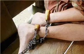  ?? — AFP ?? Trapped in iron: A man with a mental health condition shackled in a hut at Majene in West Sulawesi by his family.