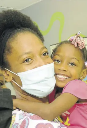  ?? (Photo: Garfield Robinson) ?? Four-year-old Kelecia Gayle and her mom Janell Mannings are a picture of joy after receiving a brand-new house courtesy of First Union Financial Limited yesterday. The company acted on an appeal by Kelecia for a house to replace the unsafe board structure in which they were living.