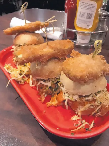  ?? JASON K. WATKINS/FOR THE JOURNAL ?? Buffalo chicken sliders are three freshly made mini rolls with shredded chicken drenched in a delicate buffalo sauce at Standard Diner.