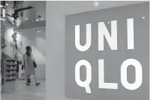  ?? Reuters-Yonhap ?? Shoppers walk inside Uniqlo casual clothing store in Tokyo in this 2014 photo.