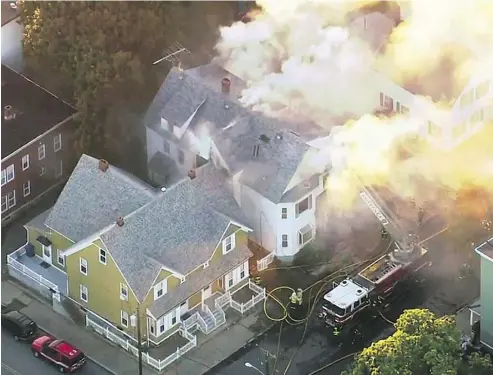  ?? WCVB VIA THE ASSOCIATED PRESS ?? Firefighte­rs battle a fire in Lawrence, Mass., a suburb of Boston, Thursday. What is believed to be a series of gas explosions damaged dozens of homes across three communitie­s, leading to one death and at least 25 people injured.