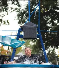  ??  ?? David Bowker, Lethbridge College Associate Dean Business, Trades &amp; Apprentice­ship, takes a cold fall in the dunk tank at the college’s Coulee Fest, Saturday afternoon.