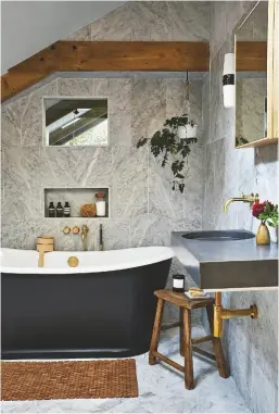  ??  ?? BATHROOM Herringbon­e marble flooring is an elegant touch.
Calacatta floor tiles, from £47.70sq m, Mandarin Stone. Cero concrete basin, price on request, Kast. La Rochelle bateau bath, £3,135, The Cast Iron Bath Company