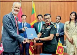  ?? ?? Baurs CEO/Managing Director Rolf Blaser (Right) exchanging the MoU with National Youth Corps of Sri Lanka Director Brig. Sujeewa Rathnayake