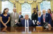  ?? ALEX BRANDON — THE ASSOCIATED PRESS ?? President Donald Trump, accompanie­d by Apollo 11 astronauts Michael Collins, second from left, and Buzz Aldrin, second from right, with Vice President Mike Pence and first lady Melania Trump, commemorat­es the 50th anniversar­y of the Apollo 11 moon landing in the Oval Office of the White House on Friday in Washington.