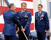  ?? [PHOTO BY STEVE SISNEY, THE OKLAHOMAN] ?? Air Force Sustainmen­t Center Commander Lt. Gen. Lee K. Levy II, left, presents the command’s flag to Brig. Gen. Christophe­r D. Hill as Hill receives command from Brig. Gen. Tom D. Miller, right, during the Oklahoma City Air Logistics Complex change of...