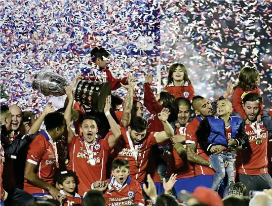  ??  ?? os
ff
Chile players celebrate with the Copa America trophy in Santiago on Saturday. — AFP