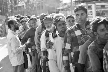  ??  ?? People stand in line to check their names on the first draft of the National Register of Citizens (NRC) at Gumi village of Kamrup district in the Indian state of Assam.— AFP photo