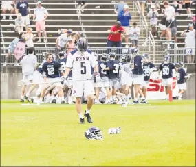  ?? Steve Musco / Yale University Athletics ?? Penn defender Mike Mulqueen holds his head down as the Yale team piles on Jack Tigh, who scored the game-winner for Yale in overtime.