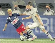  ?? AP FILE ?? Revolution midfielder Diego Fagundez, left, of Leominster, and Impact midfielder Lassi Lappalaine­n vie for control of the ball during the second half on Sept. 23 in Foxboro.