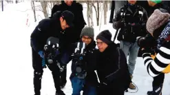  ??  ?? In this photo provided by 2016 The Japan Foundation/UNIJAPAN, Filipino director Brillante Mendoza, third from left in front, battles with snow he has not known when making films back home, directing his segment for ‘Reflection­s,’ the first film...