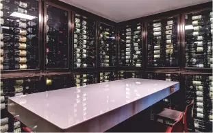  ??  ?? Above: the wine library at 67 Pall Mall contains thousands of bottles