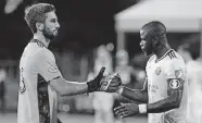  ?? [DOUGLAS DEFELICE/USA TODAY SPORTS] ?? Crew defender Jonathan Mensah, right, celebrates with goalkeeper Andrew Tarbell after a 1-0 victory over Atlanta United on Tuesday.