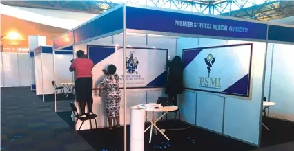  ??  ?? Premier Service Medical Aid employees put finishing touches to their stand ahead of the inaugural CBZ Internatio­nal SMEs Indaba at ZITF in Bulawayo yesterday