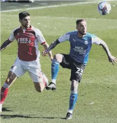  ??  ?? Joe Ward (blue) playing for Posh at Fleetwood on Good Friday.