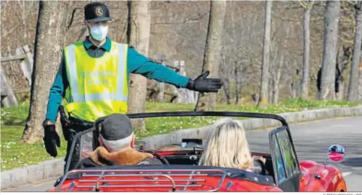  ?? ALBERTO MORANTE / EFE ?? Un agente de la Guardia Civil da el alto ayer a un automóvil en la subida del Naranco (Asturias).