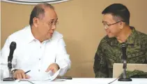  ??  ?? ARMED Forces Spokesman Brig. General Restituto F. Padilla, Jr. joins his Malacañang counterpar­t Ernesto C. Abella in Monday’s Palace briefing.