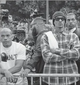  ?? Richard Vogel/AP ?? Rapper Snoop Dogg, center, leads a march in support of unificatio­n outside of the graduation ceremony for the latest class of Los Angeles Police recruits in Los Angeles, Friday, July 8, 2016. The group were looking to bring a peaceful gathering of...