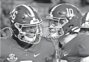  ?? GARY COSBY JR./THE TUSCALOOSA (ALA.) NEWS ?? Wide receiver DeVonta Smith, left, and quarterbac­k Mac Jones posted record-setting gains in Alabama’s title win.