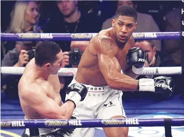  ??  ?? Anthony Joshua (R) of Great Britain goes on the offensive against Joseph Parker (L) of New Zealand during their heavyweigh­t unificatio­n bout at Principali­ty Stadium in Cardiff, March 31, 2018. - AFP photo