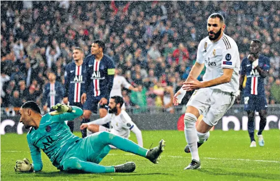  ??  ?? Bright start: Karim Benzema beats PSG goalkeeper Keylor Navas from close range to give Real Madrid an early lead