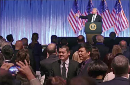  ?? SUSAN WALSH — THE ASSOCIATED PRESS ?? People in the audience have their photo taken as President Donald Trump speaks at a fundraiser at Cipriani in New York, Saturday. Trump is attending a trio of fundraiser­s during his day in New York.