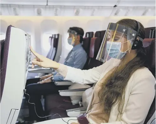  ??  ?? 0 Qatar Airways has become one of the first carriers to require passengers to wear face shields as well as masks aboard aircraft