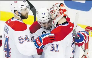  ?? DARIO AYALA/MONTREAL GAZETTE ?? Carey Price is congratula­ted by teammates Alexei Emelin and Greg Pateryn after winning Game 4 of their Eastern Conference semifinal on Thursday.