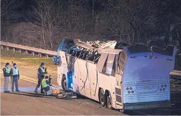  ?? AP ?? A bus carrying students stops on the side of a highway after it hit an overpass on the Southern State Parkway in Lakeview, New York.