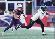  ?? Adam Glanzman / Getty Images ?? Jets receiver Elijah Moore catches a pass during the second quarter against the New England Patriots at Gillette Stadium on Sunday in Foxborough, Mass.