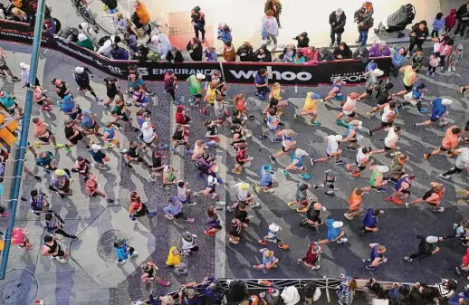  ?? Robin Jerstad/contributo­r ?? Runners leave the starting line at the Rock N' Roll Marathon on a damp Sunday morning in downtown San Antonio.