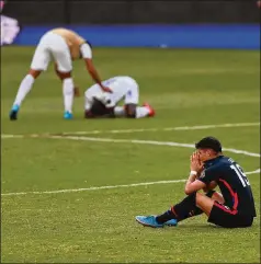  ?? FERNANDO LLANO/ASSOCIATED PRESS ?? The United States’ Sebastian Soto sits in despair at the end of the men’s Olympic qualifying championsh­ip semifinal match against Honduras, which defeated United States 2-1, denying the Americans a chance at the upcoming Tokyo Olympics.
