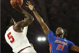  ?? JOSHUA L. JONES — ATHENS BANNER-HERALD ?? Georgia’s Anthony Edwards (5) tries to get a shot past Florida forward Dontay Bassett (21) on March 4 in Athens, Ga. Edwards is considered one of the top picks in this year’s NBA Draft.