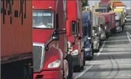  ?? Luis Sinco Los Angeles Times ?? TRUCKS IDLE as drivers wait to enter a terminal at the Port of Long Beach. Regulators aim to lessen truck pollution in the most vulnerable communitie­s.
