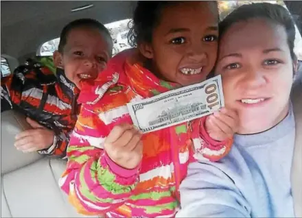  ?? PHOTO COURTESY OF DAYNA FIRTH ?? Dayna Firth, right, was one of the lucky drivers to receive a $100 bill from Phoenixvil­le Police courtesy of an anonymous citizen. Her daughter, Gianna, is holding the $100 bill while her son, Julian, poses in the background.