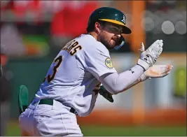  ?? PHOTOS BY JOSE CARLOS FAJARDO — BAY AREA NEWS GROUP ?? Oakland Athletics' Shea Langeliers (23) celebrates after hitting an RBI triple in the eighth inning of their game at the Coliseum in Oakland on Aug. 21, 2022.